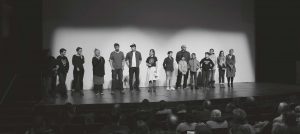 Background Image: group of ReFrame volunteers on stage