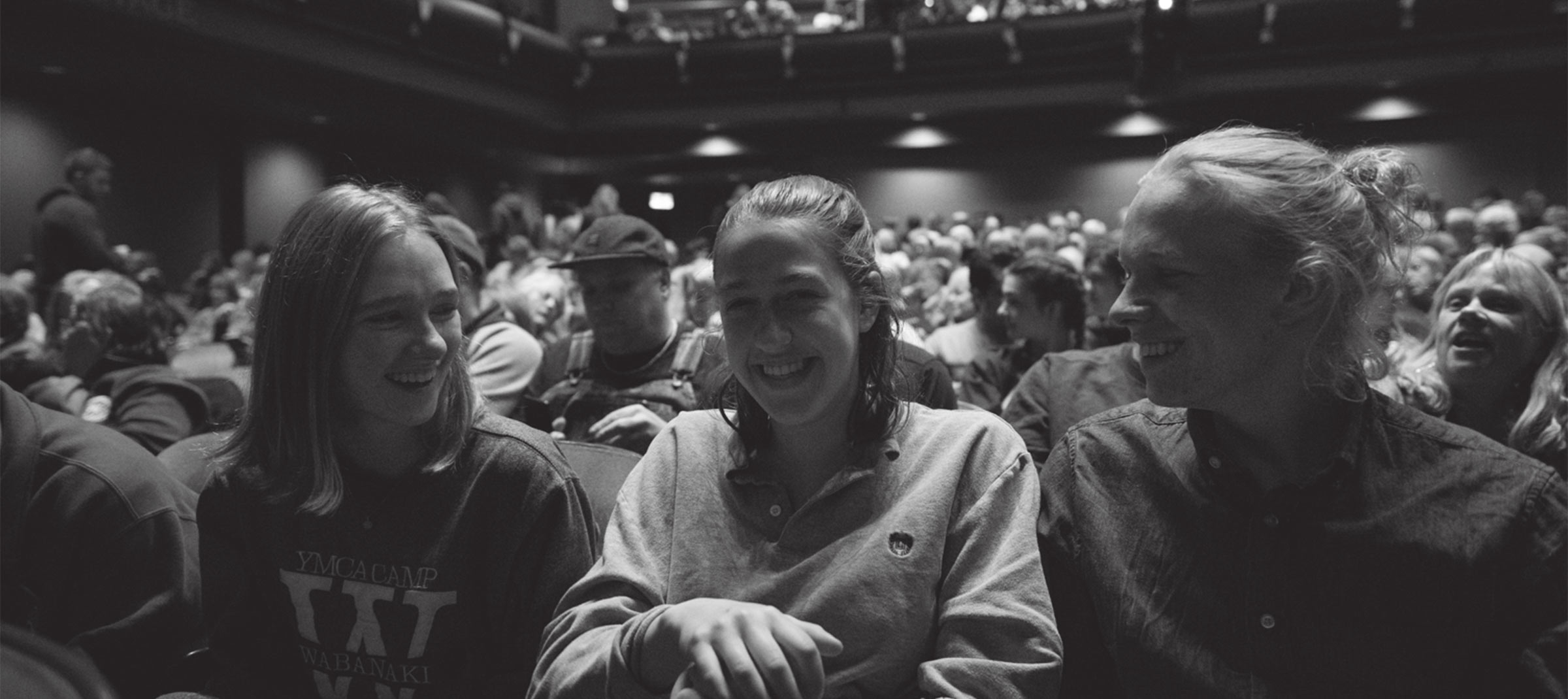 Three young people laughing together in the front row of Showplace Performance Centre at ReFrame 2020