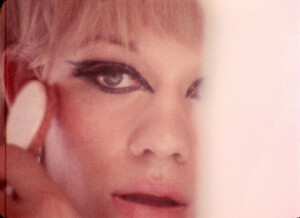 A still from The Queen, featuring a drag queen applying makeup in preparation for a pageant.